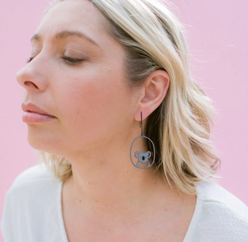 Woman wearing the Denz Koala dangle earrings