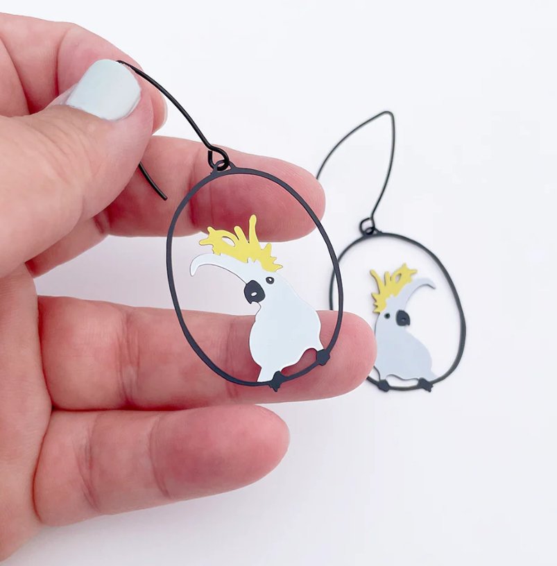DENZ Midi Sulphur Crested Cockatoo Earrings, held by hand