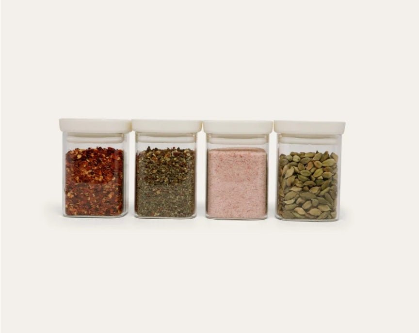Seed & Sprout Newrybar Spice Jar Set filled with chili flakes, herbs, pink salt, and cardamom.