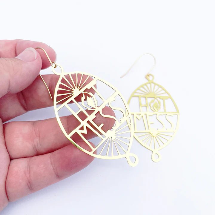 DENZ Hot Mess in Gold earrings, held by hand