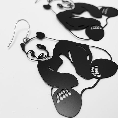 DENZ Pandas in black earrings, angled view