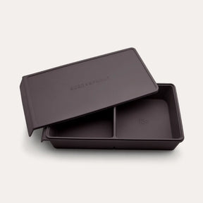 An open Seed & Sprout 2 Portion Macadamia Silicone Freezer Tray with two partitioned sections and its matching embossed lid resting partially on top.