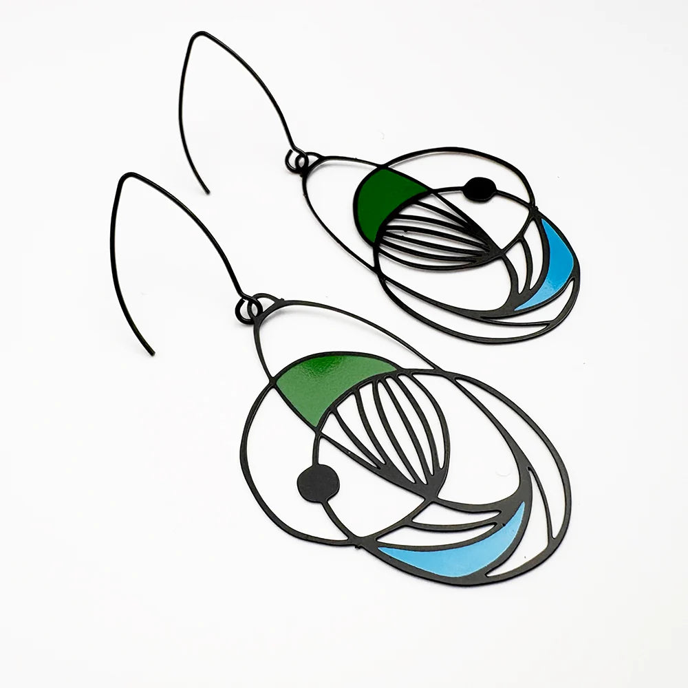 Pair of DENZ Art School Drop Out Earrings in Cool with a circular design featuring green, blue, and black on a white background