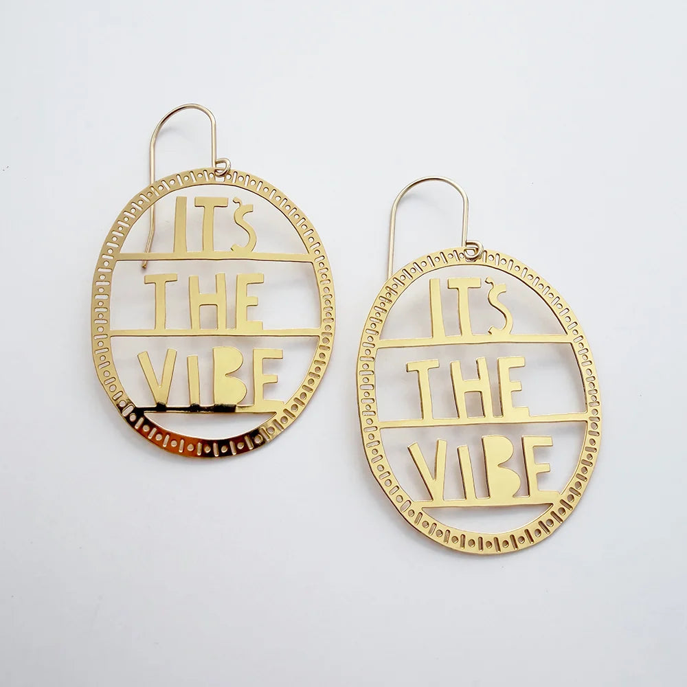 DENZ It's The Vibe earrings in gold with detailed patterned oval hoop in white background