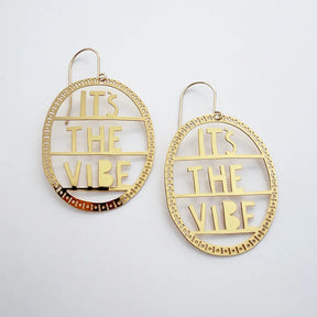 DENZ It's The Vibe earrings in gold with detailed patterned oval hoop in white background