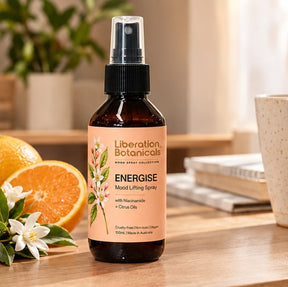 Liberation Botanicals Energise Mood Lifting Spray 100mL with niacinamide and citrus oils styled in a bright setting.