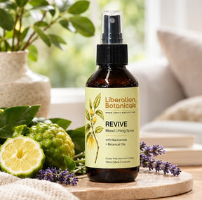 Liberation Botanicals Revive Mood Lifting Spray styled with natural ingredients in a home setting.