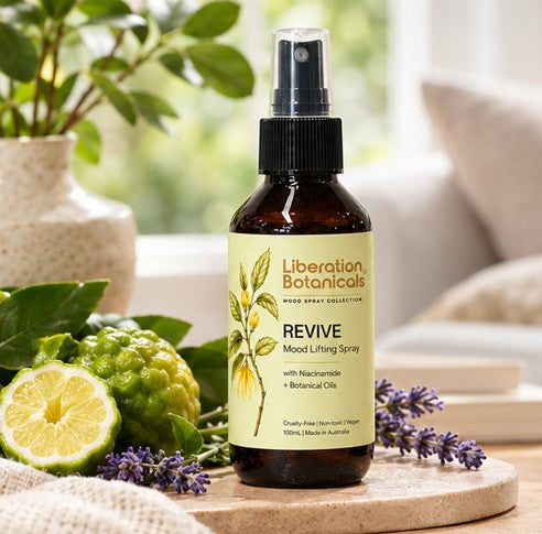 Liberation Botanicals Revive Mood Lifting Spray styled with natural ingredients in a home setting.
