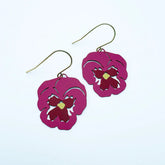 A pair of DENZ dangling earrings with magenta-pink flower-shaped cutouts and gold-tone fishhook wires, shown on a plain white background.