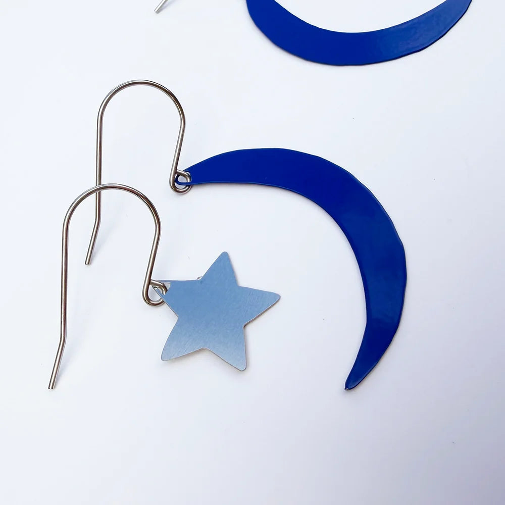 DENZ Moon & Star Stacker Silver-toned metal dangle earrings featuring a crescent moon and star design, shown on a clean white background.
