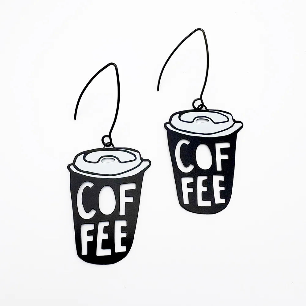 A pair of DENZ Coffee Cup  earrings with the word 'COFFEE' printed on them, shown against a plain white background.