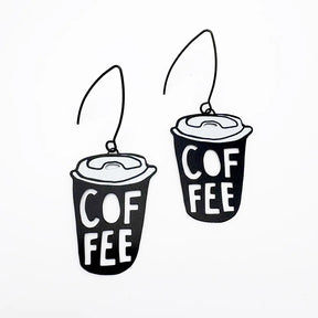 A pair of DENZ Coffee Cup  earrings with the word 'COFFEE' printed on them, shown against a plain white background.