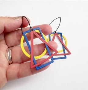 Denz Basic Shape Earrings in Primarys, held by hand