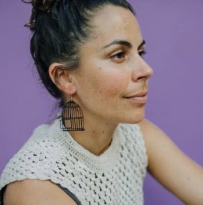 Side profile of a woman wearing the Denz Birdcage & Bird Earrings in Black & Duck Egg 