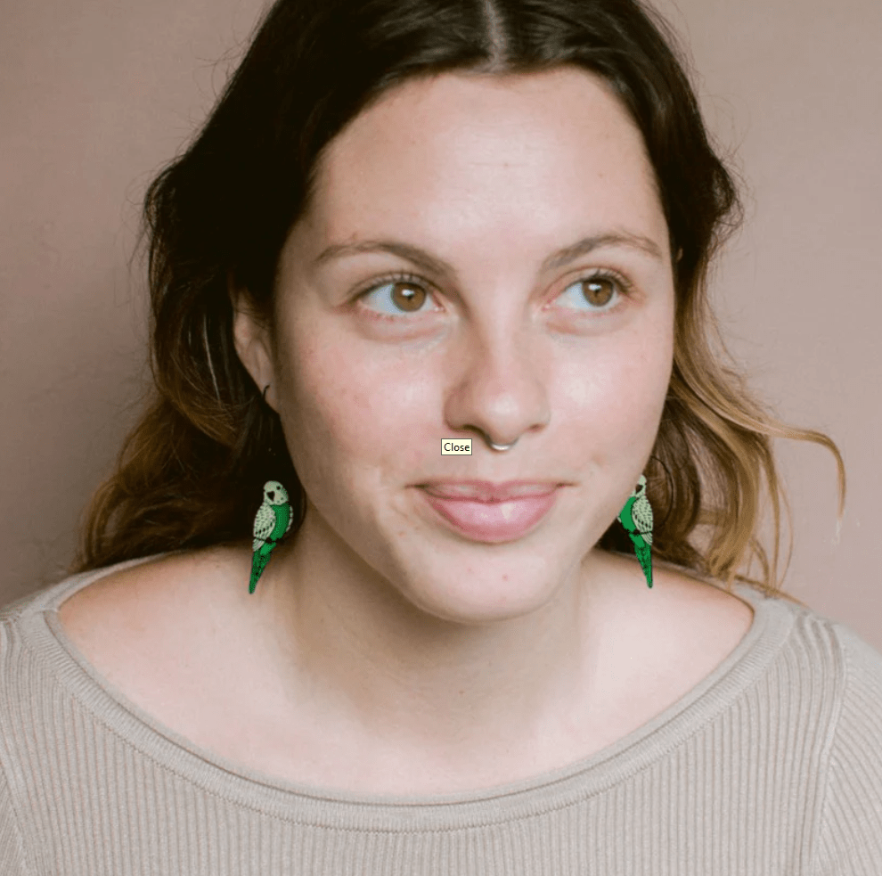 Woman wearing the DENZ Budgies Earrings in Black/Green/Yellow 