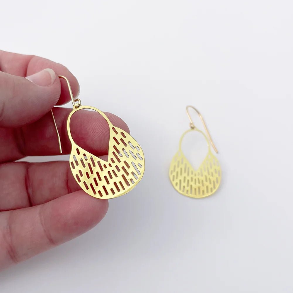 DENZ Mini Callisia Earrings in Gold, held by hand