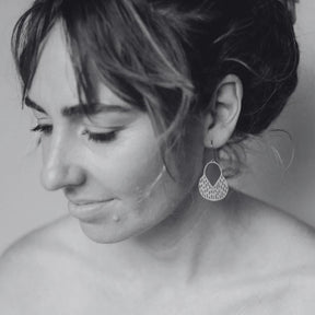 Side profile of a woman looking down while modelling DENZ MIni Callisia Earrings in Gold 
