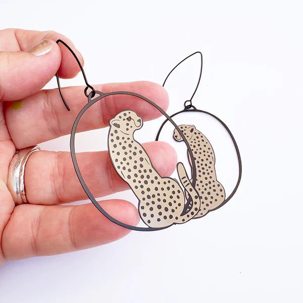 Denz Cheetah earrings in Black/Tan, held by hand