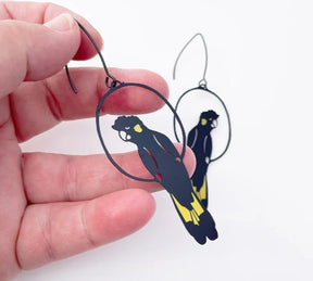 DENZ Yellow Tailed Black Cockatoo Earrings, held by hand