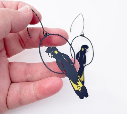 DENZ Yellow Tailed Black Cockatoo Earrings, held by hand