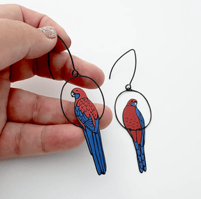 DENZ Crimson Rosella earrings, held by hand