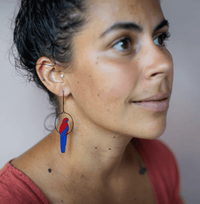 Side profile of a woman wearing the DENZ Crimson Rosella earrings 