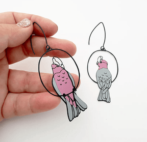 DENZ Galah Earrings, held by hand