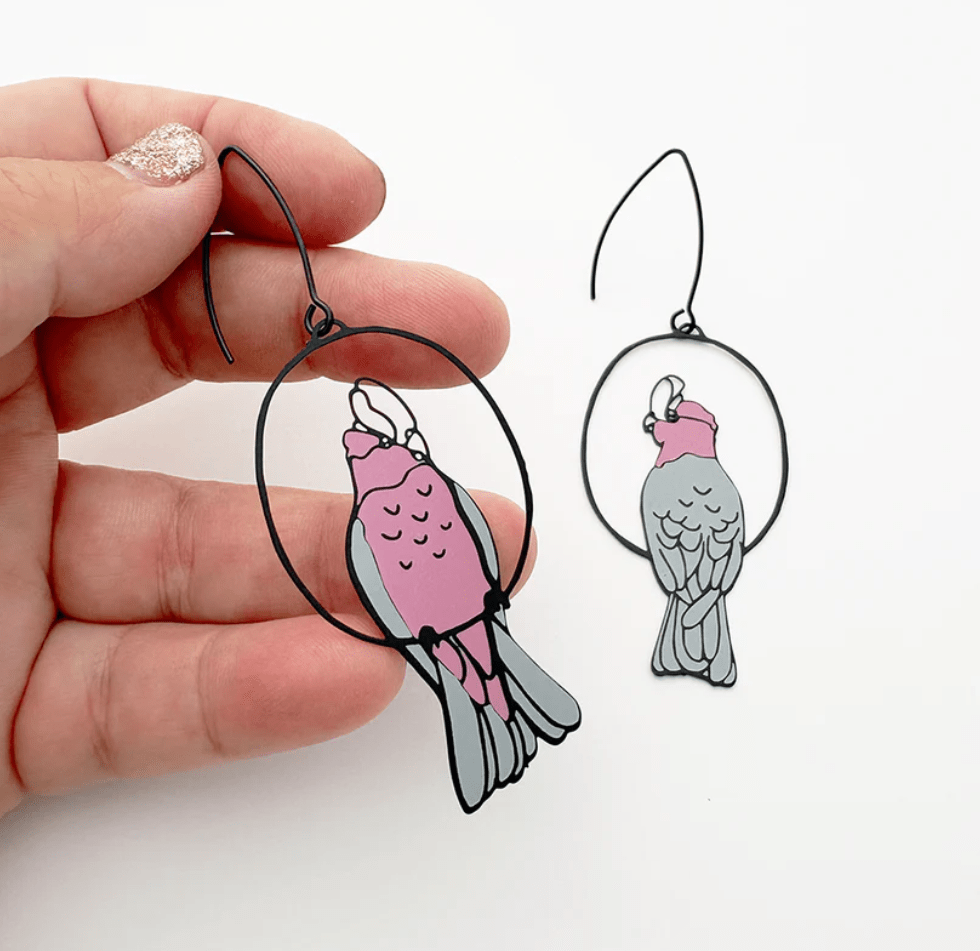 DENZ Galah Earrings, held by hand