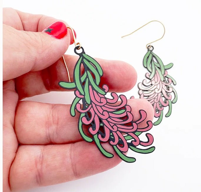 Denz Grevillea Flower Earrings in Black/Green/Pink, held by hand