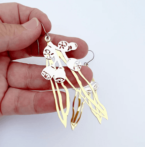 DENZ Gumnut & Leaf dangle earrings in Gold/Silver, held by hand