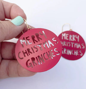 Denz Merry Christmas Grinches Earrings in Red, held by hand