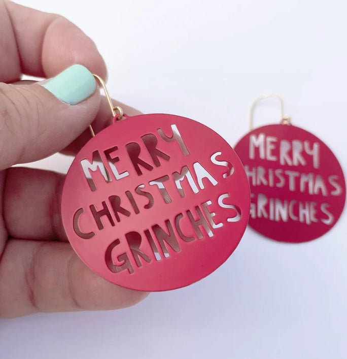 Denz Merry Christmas Grinches Earrings in Red, held by hand
