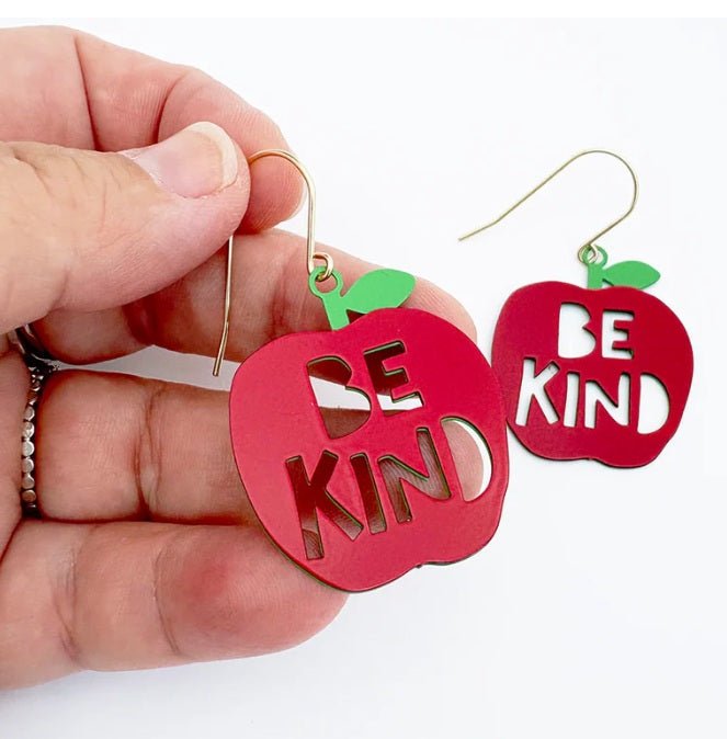 Denz Midi Be Kind Apple Earrings in Red/Green, held by hand