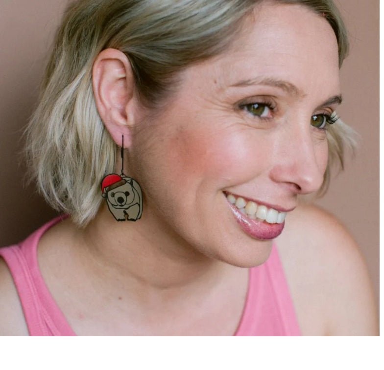Side profile of a woman wearing Denz Midi Christmas Wombat Earrings in Black/Brown/Red 