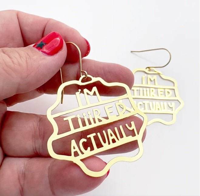 Denz Midi I'm Tiiired Actually earrings in Gold, held by hand