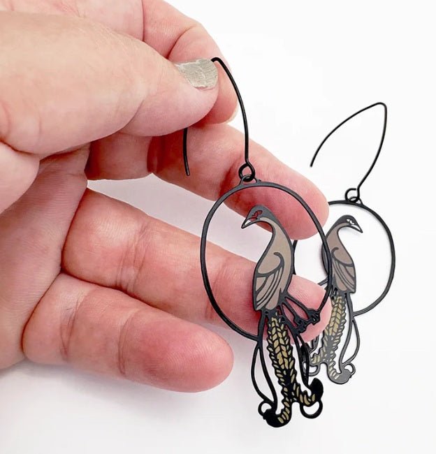 Denz Midi Lyrebird Earrings in Black/Brown, held by hand