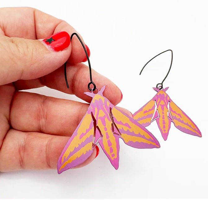 Denz Midi Moth Earrings in Elephant Hawk, held by hand 