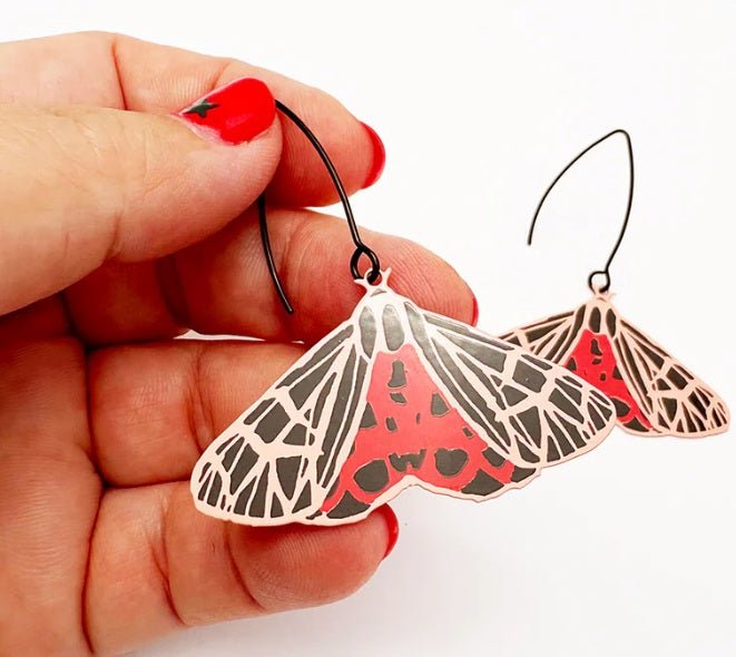 Denz Midi Moth Earrings in Ornate Tiger, held by hand 