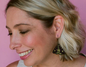 Side profile of a woman wearing Denz Midi Moth Earrings in Sheep Moth 