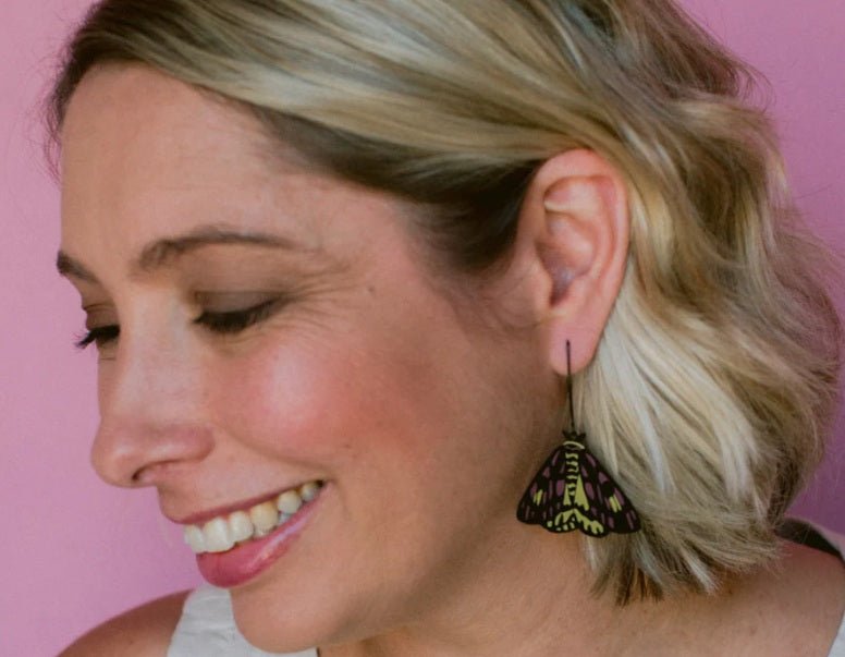Side profile of a woman wearing Denz Midi Moth Earrings in Sheep Moth 
