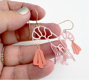 Denz Midi Prawn Dangle Earrings in Coral, held by hand