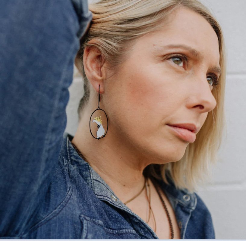 Woman is wearing the DENZ Midi Sulphur Crested Cockatoo Earrings 