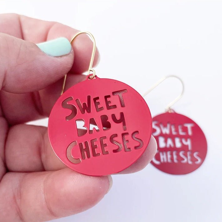 Denz Mini Sweet Baby Cheeses Earrings in Red, held by hand