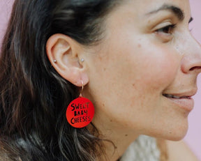 Side profile of a woman wearing Denz Mini Sweet Baby Cheeses Earrings in Red 