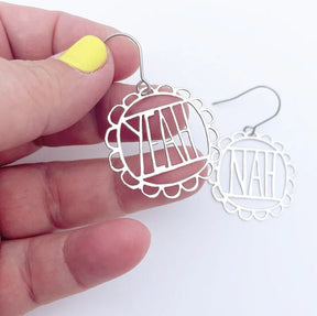 Denz Mini YEAH/NAH Earrings in Silver, held by hand