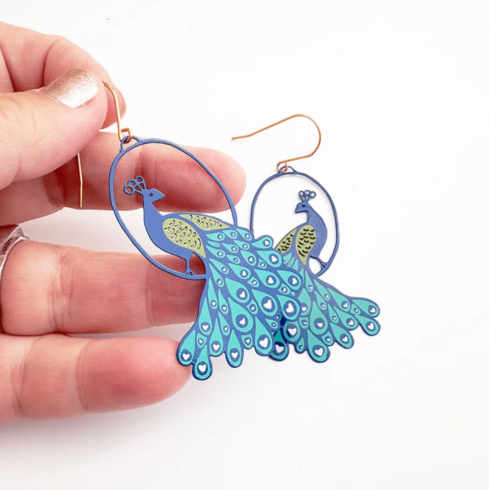 DENZ Peacock earrings in Blues, held by hand