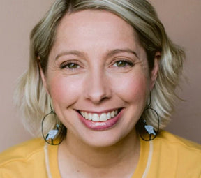 Woman smiling wearing the Denz Sacred Ibis Earrings in Black/White 