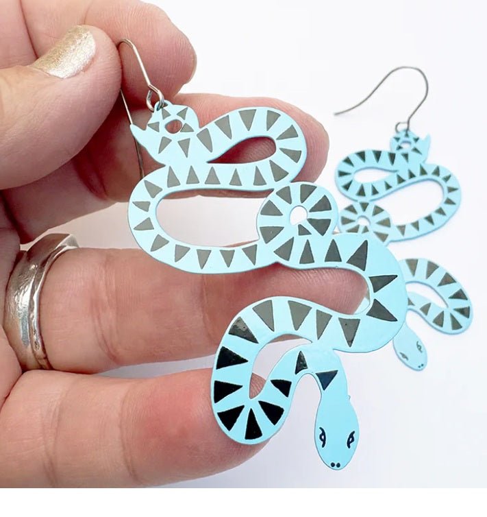 Denz Snake Earrings in Blue/Black, held by hand