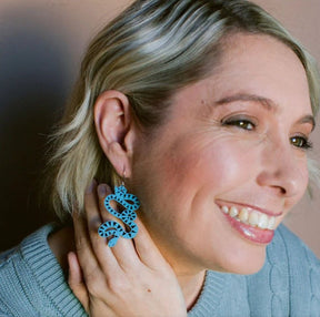 Side profile of  woman wearing the Denz Snake Earrings in Blue/Black 
