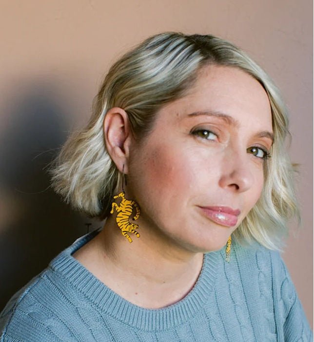 Woman wearing the Denz Tiger Earrings in Orange/Black